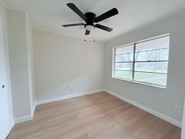 spare room with ceiling fan and light wood-type flooring