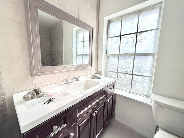 bathroom featuring toilet, tile patterned floors, and vanity