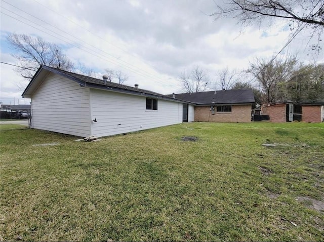 back of property featuring a lawn