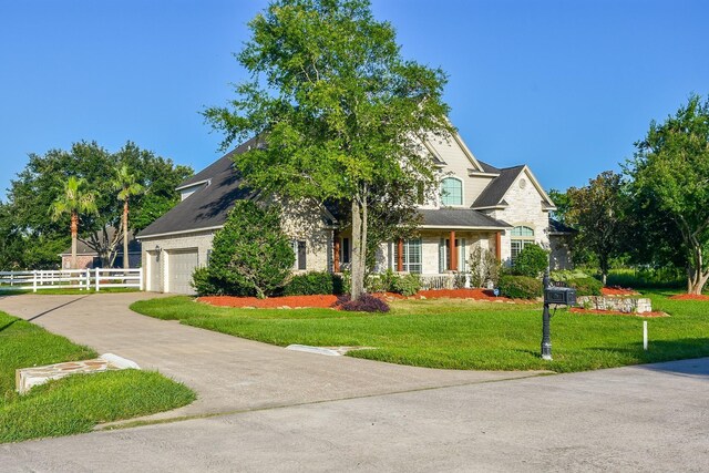 view of front of property with a garage and a front lawn