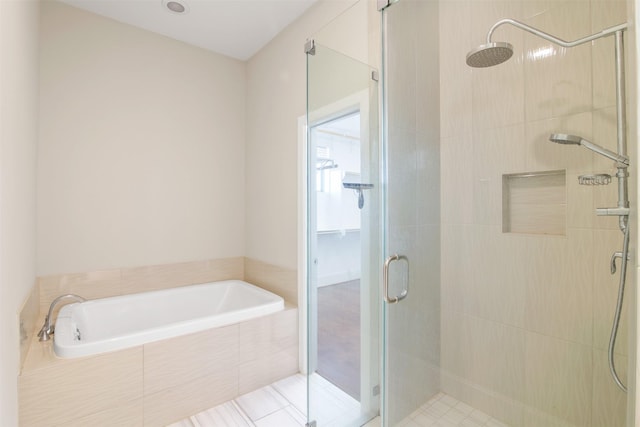 bathroom with shower with separate bathtub