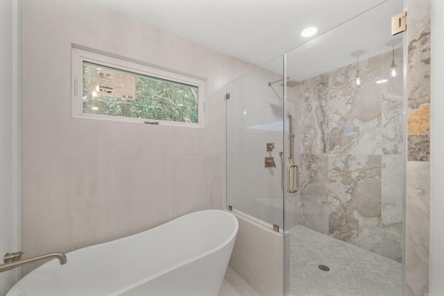 bathroom with separate shower and tub