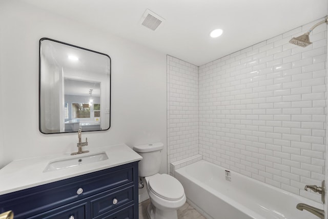 full bathroom featuring toilet, vanity, and tiled shower / bath combo