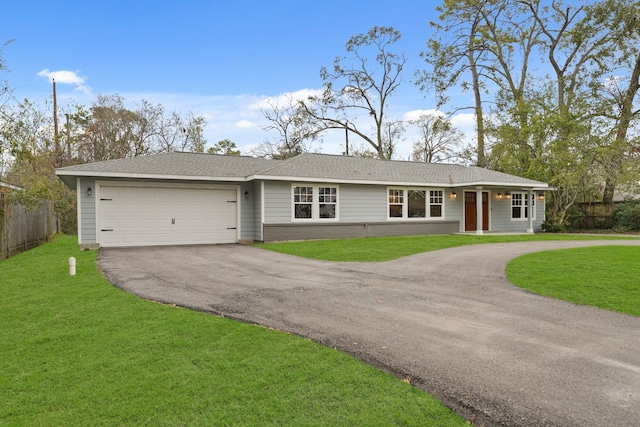 single story home featuring a garage and a front yard