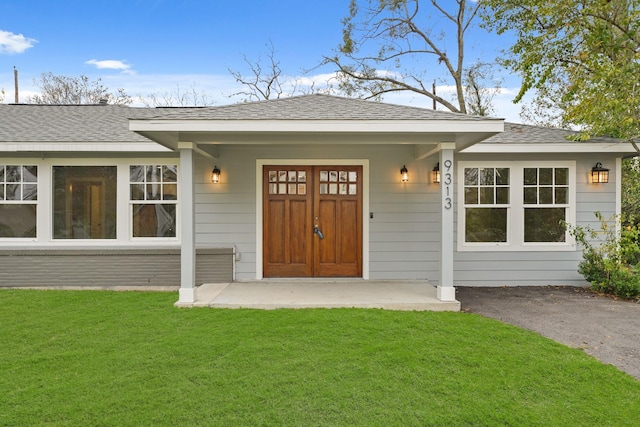 doorway to property with a lawn