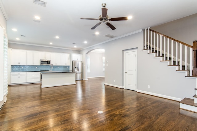 unfurnished living room featuring ceiling fan, crown molding, dark hardwood / wood-style floors, and sink