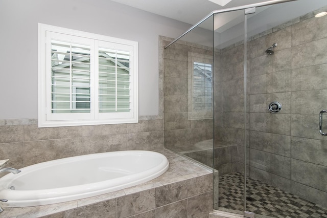 bathroom with shower with separate bathtub