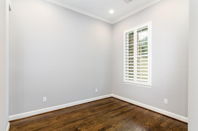 spare room with dark hardwood / wood-style flooring and crown molding