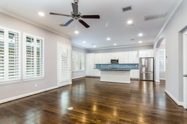 unfurnished living room featuring ceiling fan, dark wood-type flooring, and crown molding