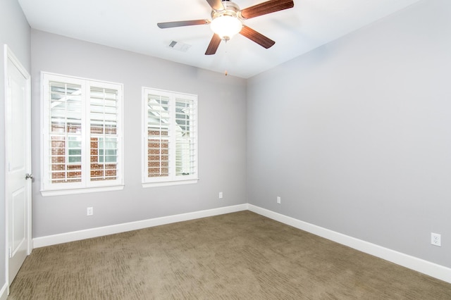 spare room with ceiling fan and carpet flooring