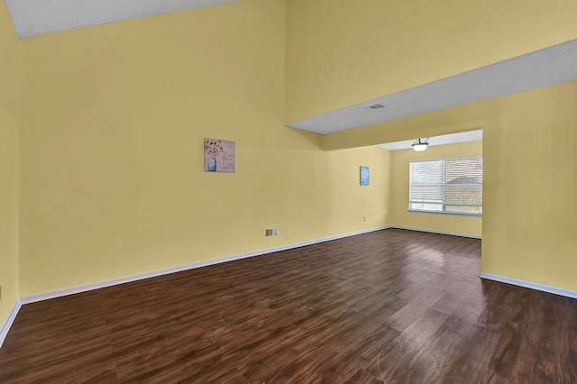 empty room with dark hardwood / wood-style floors