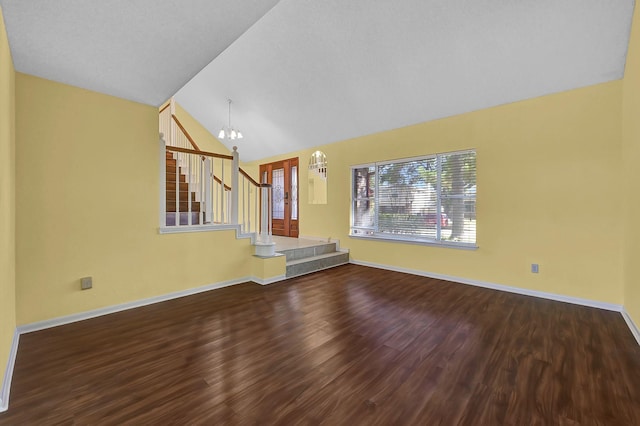 unfurnished living room with high vaulted ceiling, a chandelier, and hardwood / wood-style flooring