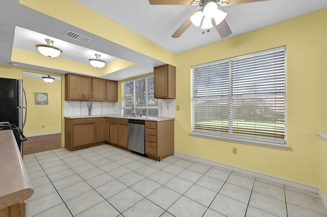 kitchen featuring decorative backsplash, appliances with stainless steel finishes, ceiling fan, and light tile patterned flooring