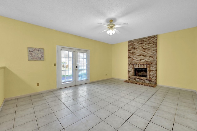 unfurnished living room with light tile patterned floors, ceiling fan, a fireplace, french doors, and a textured ceiling