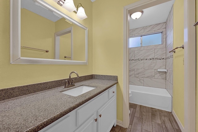 full bathroom featuring toilet, vanity, and tiled shower / bath