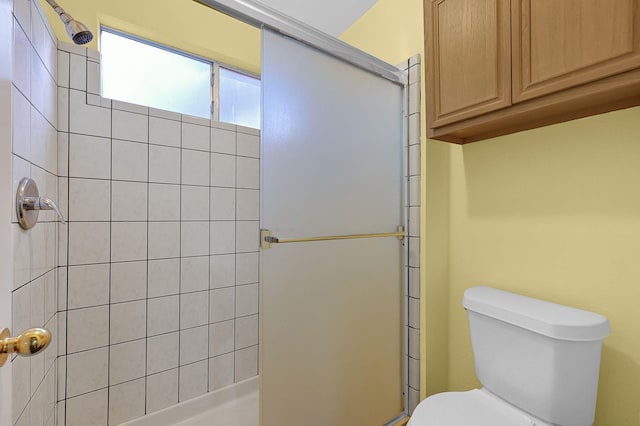 bathroom featuring walk in shower and toilet