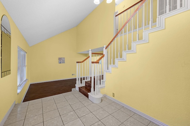 tiled entryway with lofted ceiling