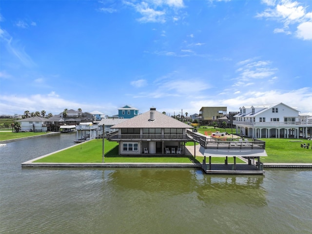 dock area featuring a lawn and a water view