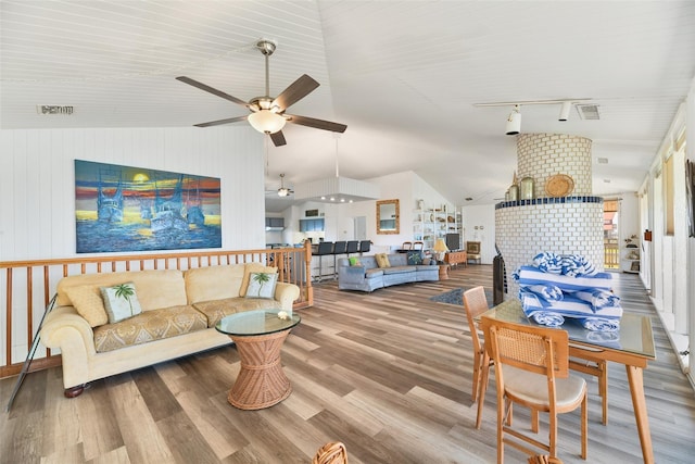 living room featuring ceiling fan, wood-type flooring, and vaulted ceiling