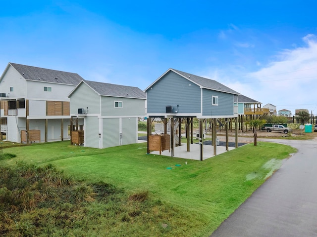 back of property featuring a lawn and a patio