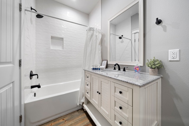 bathroom with hardwood / wood-style floors, vanity, and shower / bath combination with curtain