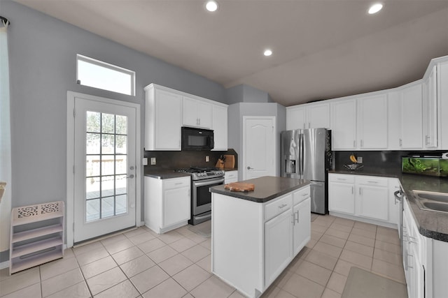 kitchen featuring white cabinets, stainless steel appliances, and a kitchen island