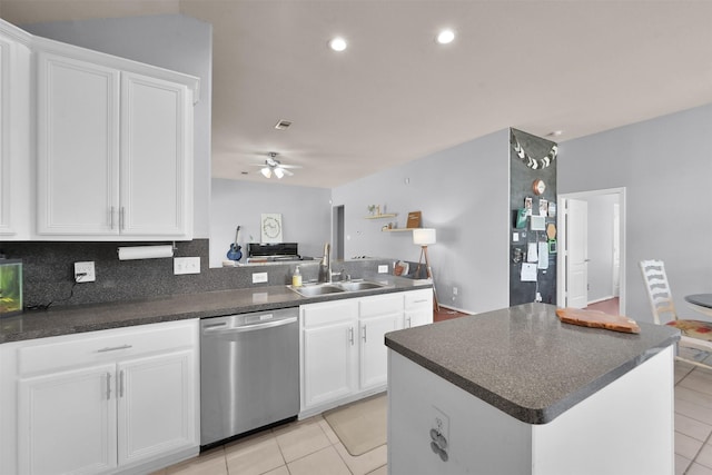 kitchen featuring white cabinets, sink, light tile patterned flooring, ceiling fan, and stainless steel dishwasher