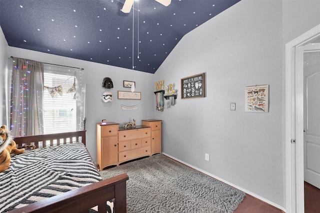 bedroom with vaulted ceiling, ceiling fan, and dark carpet