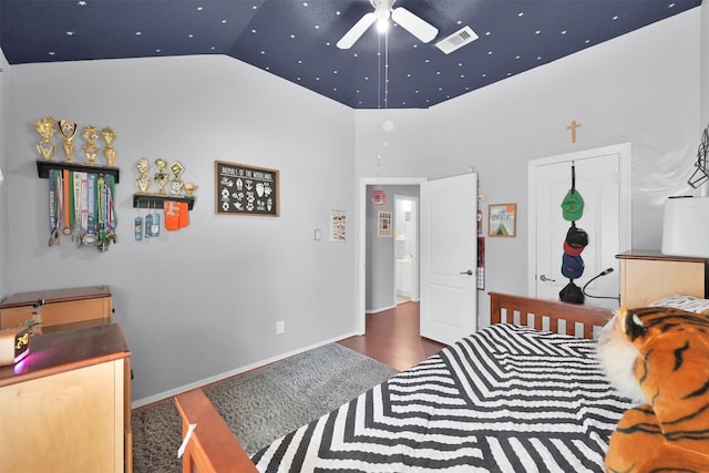 bedroom featuring high vaulted ceiling, dark wood-type flooring, a closet, and ceiling fan