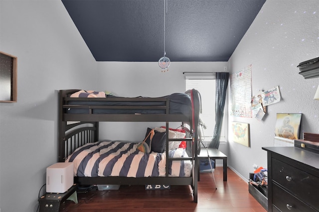 bedroom featuring lofted ceiling and wood-type flooring