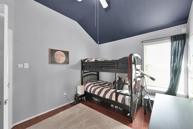 bedroom with ceiling fan, vaulted ceiling, and hardwood / wood-style floors