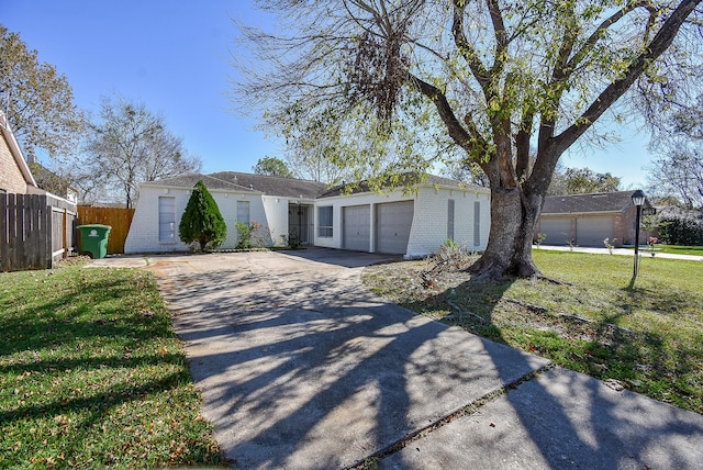 ranch-style house with a garage and a front yard