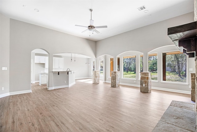 unfurnished living room with ceiling fan and light hardwood / wood-style floors