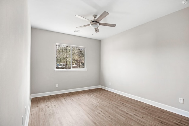 unfurnished room with ceiling fan and light wood-type flooring