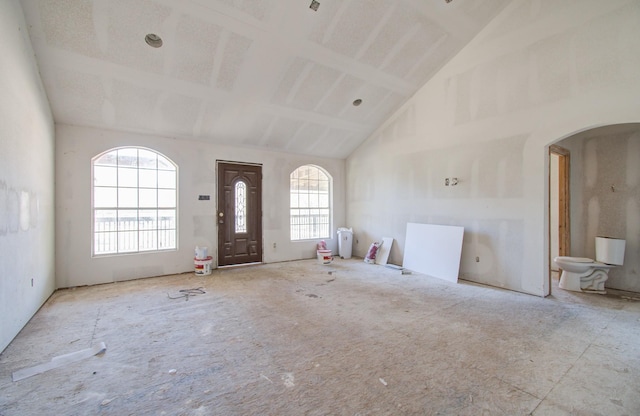 entryway featuring high vaulted ceiling