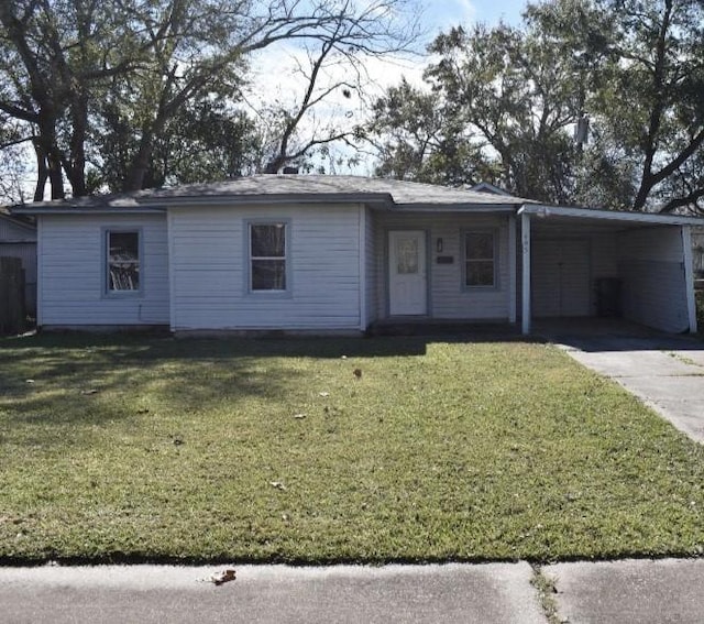 single story home featuring a front yard and a carport