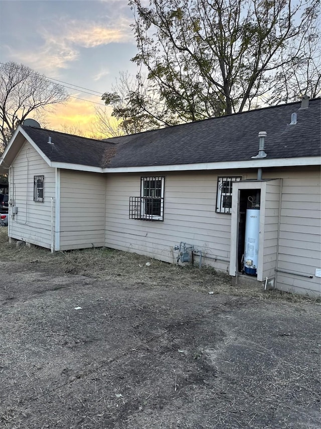 back house at dusk with gas water heater