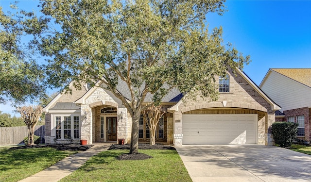 view of front of property featuring a front yard and a garage