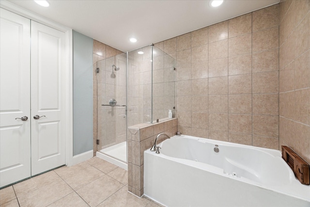 bathroom with separate shower and tub and tile patterned floors