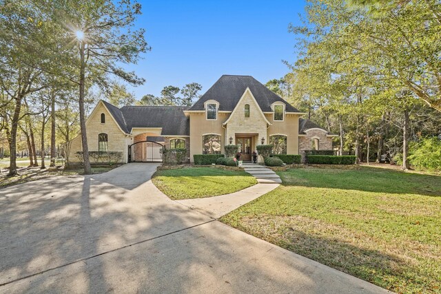 french country style house featuring a front lawn