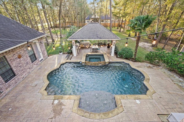 view of swimming pool featuring an in ground hot tub and a gazebo