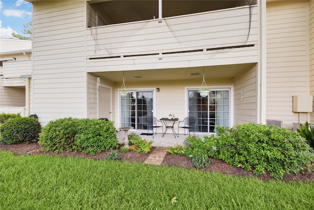 back of house with a patio area and a balcony