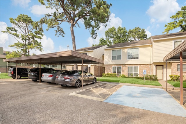 view of car parking with a carport and a yard