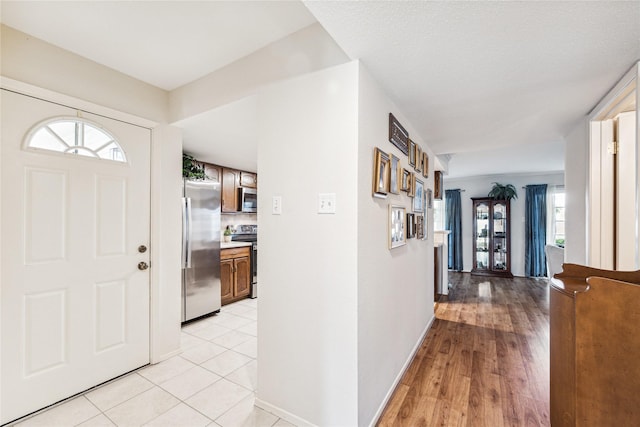 tiled foyer featuring plenty of natural light