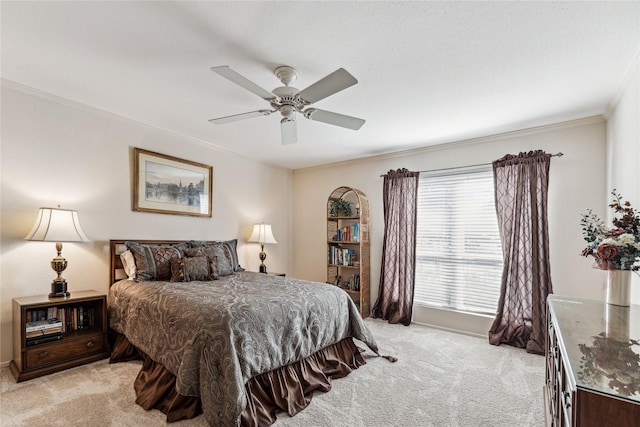 bedroom with ceiling fan, crown molding, and light colored carpet