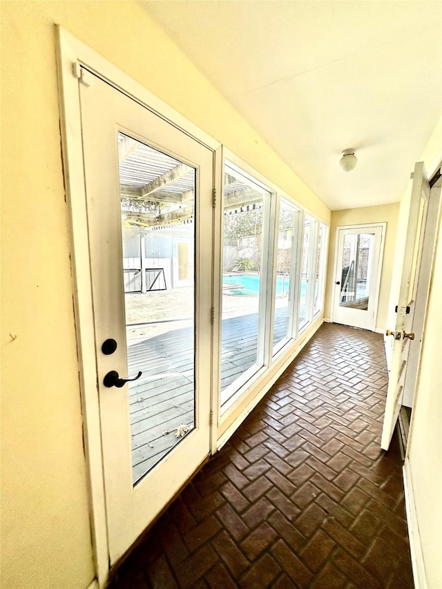 6143 Ella Lee Ln, Houston, TX 77057 - unfurnished sunroom with baseboards and brick floor