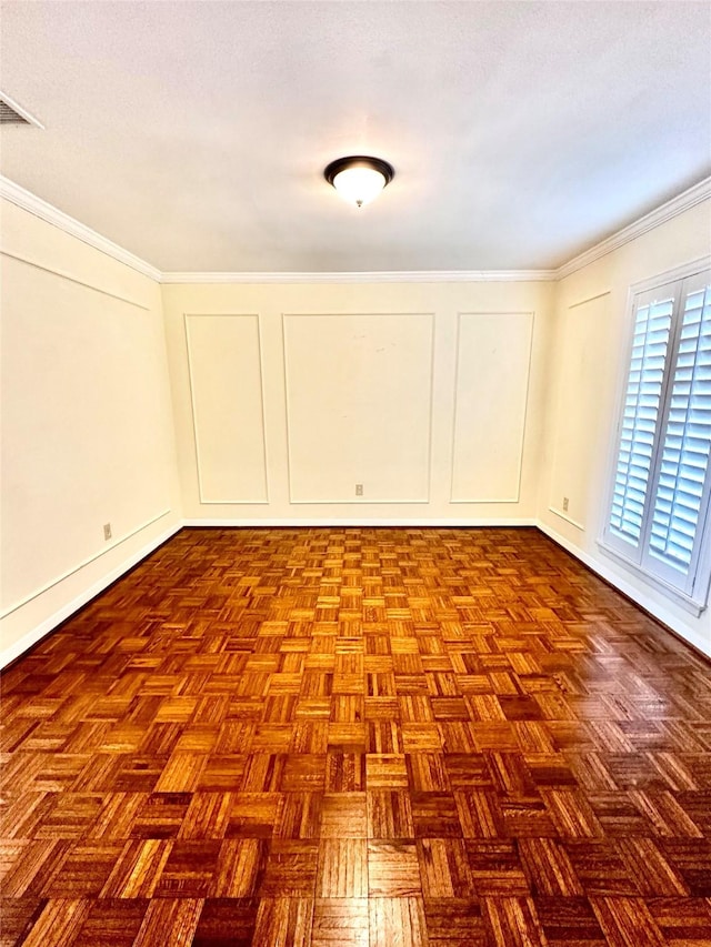 unfurnished room featuring ornamental molding and parquet floors