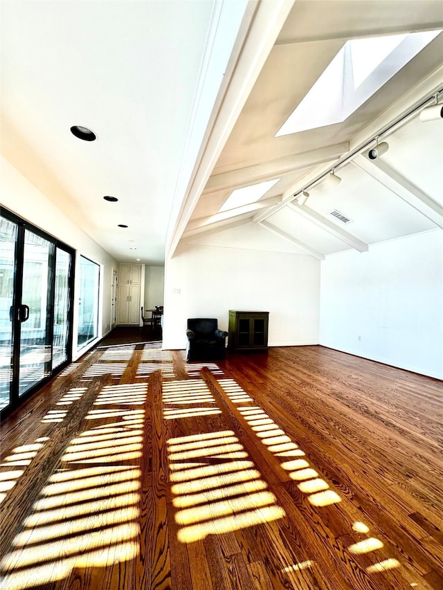 bonus room with wood-type flooring and lofted ceiling with skylight