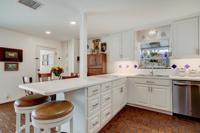 6143 Ella Lee Ln, Houston, TX 77057 - kitchen featuring stainless steel dishwasher, visible vents, a peninsula, brick floor, and a sink