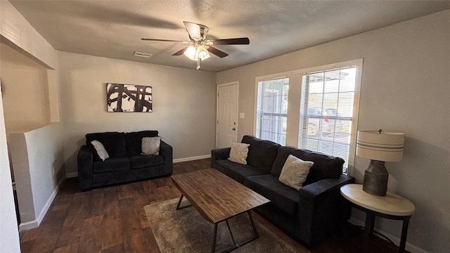 living room with ceiling fan and dark hardwood / wood-style floors